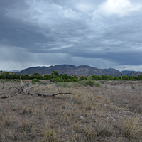 Rain over the Mogollon Mountains. Photo Credits: Mary Harner