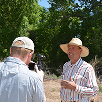 Rosdail filming interview with Joe Runyan with an Osmo handheld camera. Photo Credits: Mary Harner